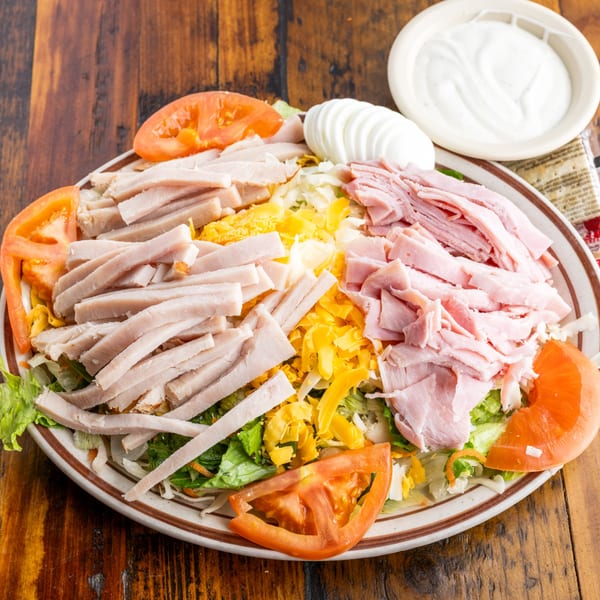 Crazy Otto's Diner chef salad with turkey, ham, cheese, tomatoes, and hard-boiled eggs.